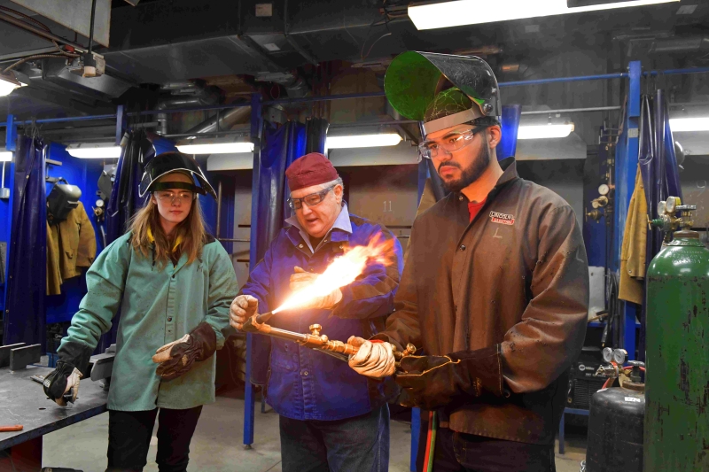 DCCC Welding students with instructor