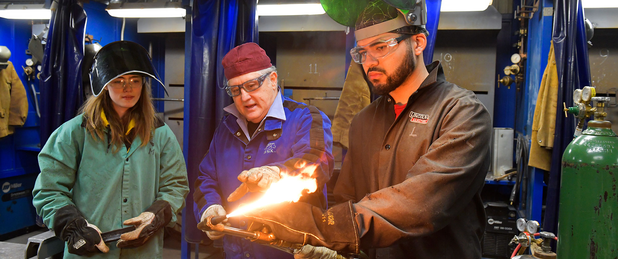 Welding class with professor and two students