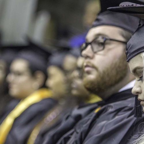 Graduating students listening